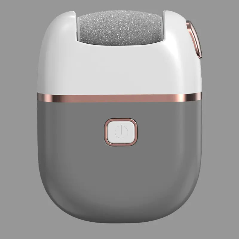 Gray and rose gold skin care device on a gray background