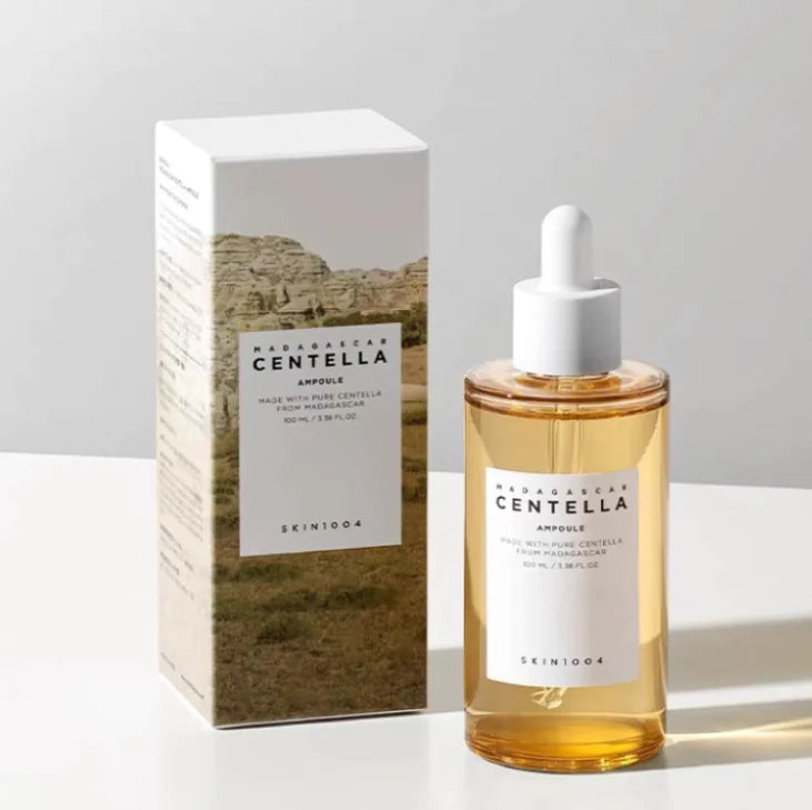 Skincare bottle with dropper and packaging on a light background