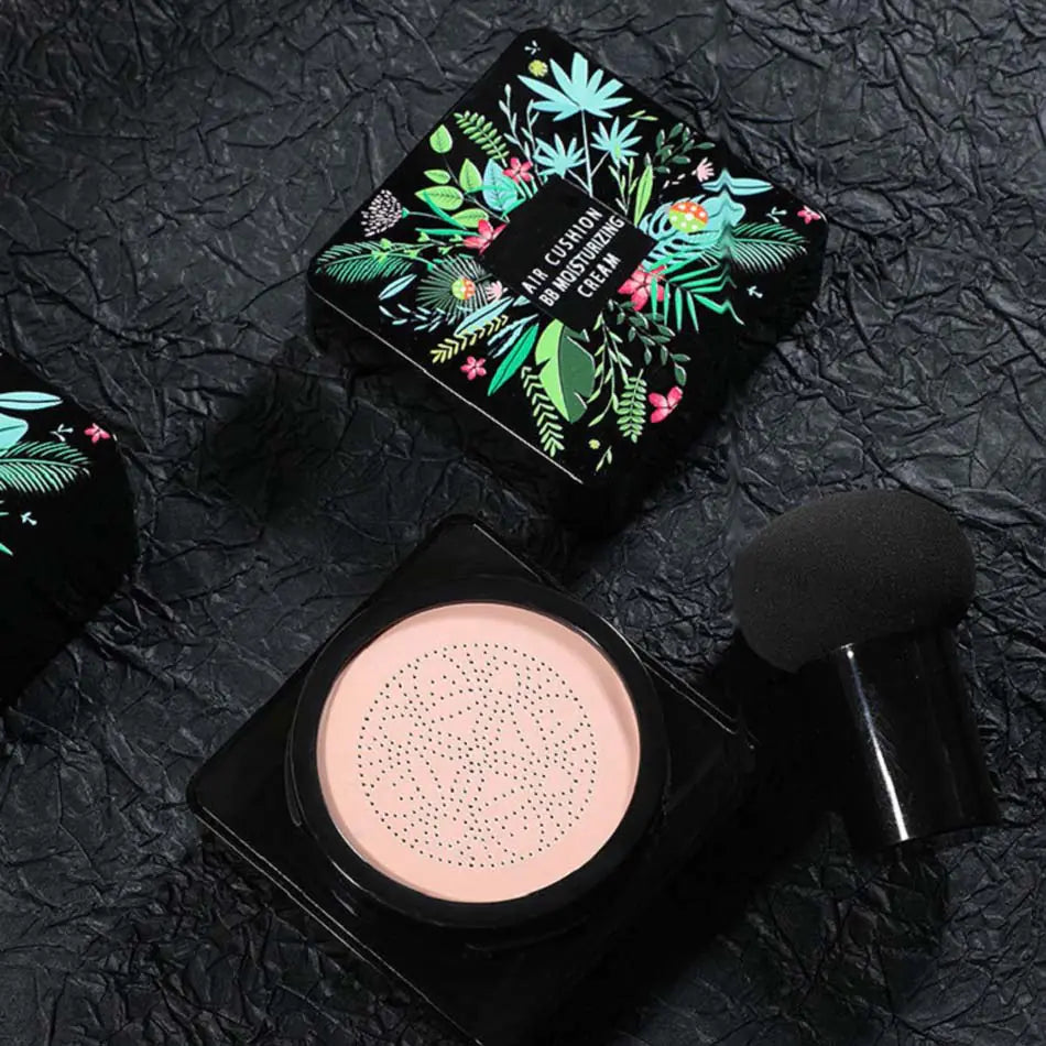 Makeup compact with floral design on lid and brush on black textured background