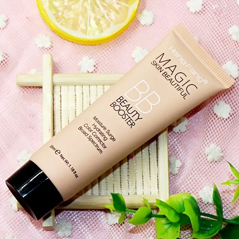BB cream tube labeled 'Magic Beautiful' on a pink floral background with a lemon slice.
