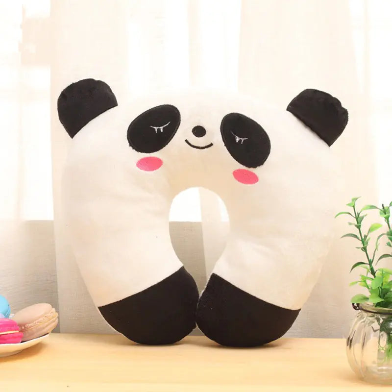Panda-shaped pillow on a table with a light background